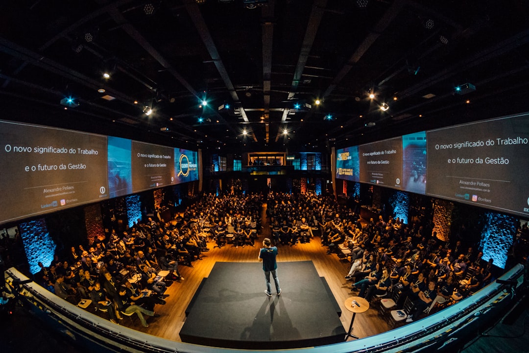 A large conference audience facing a stage at an industry event