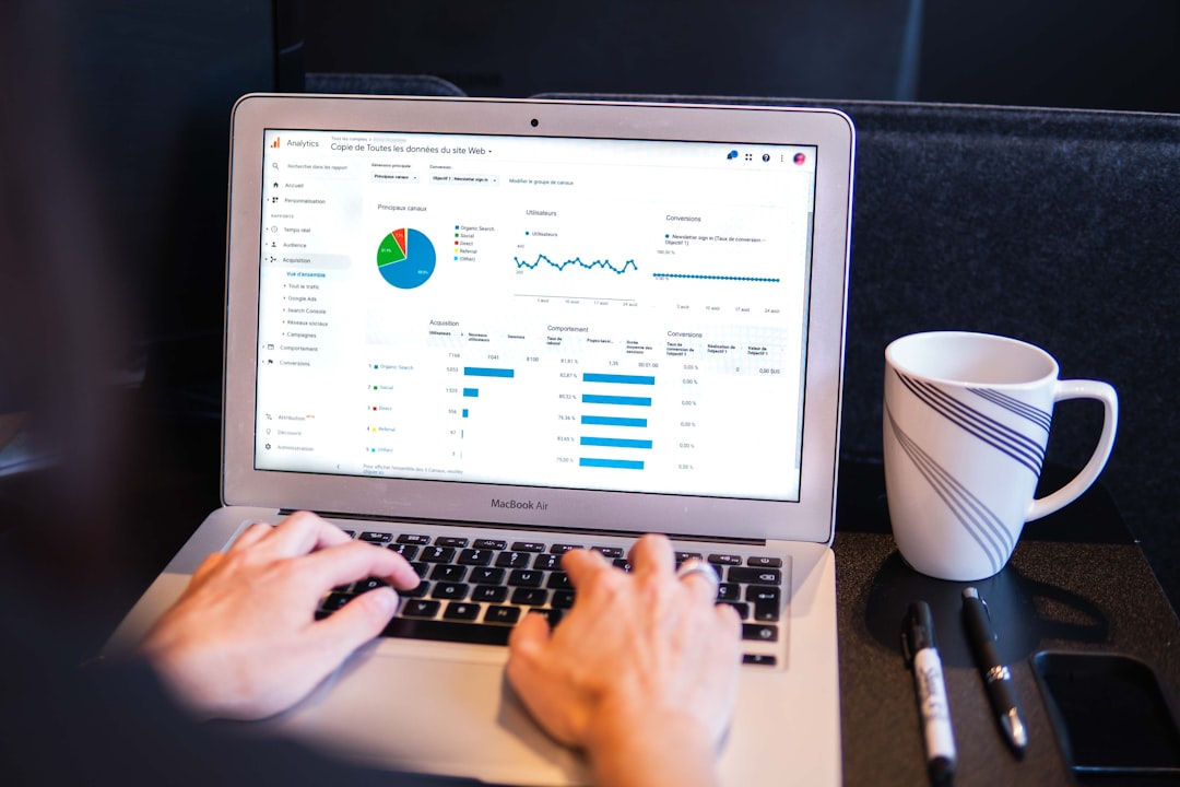 Laptop on a desk displaying a Google Ads campaign performance dashboard