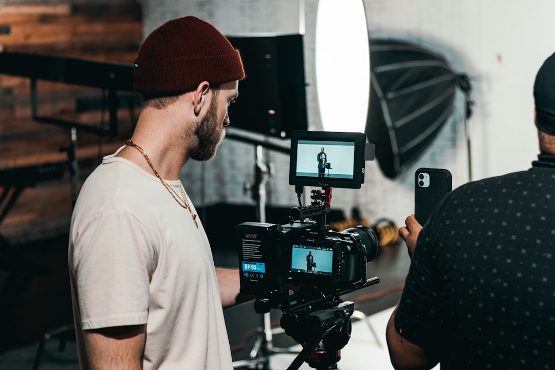Video production crew filming with a professional camera setup, representing digital video advertising