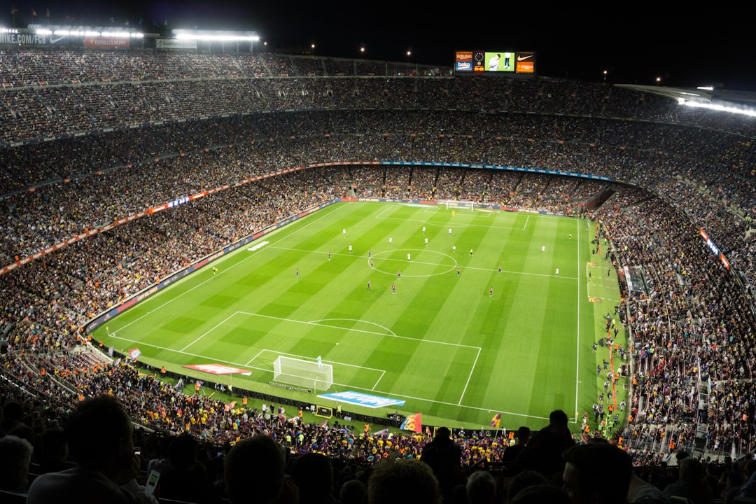 Floodlit soccer stadium filled with fans during a match