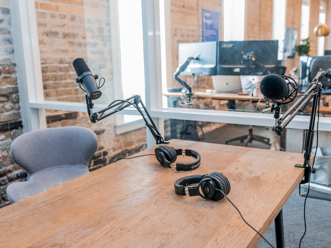 Podcast studio desk with microphones and headphones