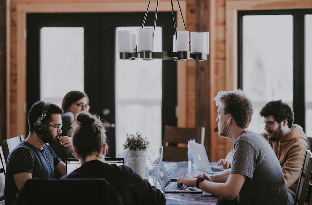 B2B sales and marketing team meeting around a table in an office