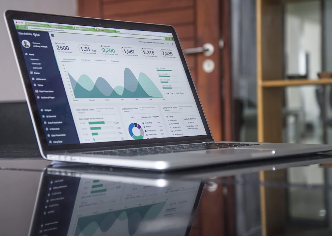 Laptop screen showing an analytics dashboard, representing AI visibility measurement for B2B brandslaptop computer on glass-top table